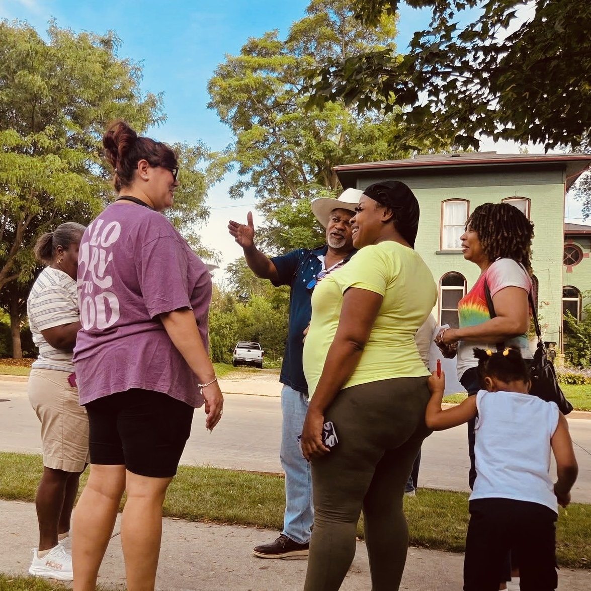Neighbors talking and laughing together on the sidewalk