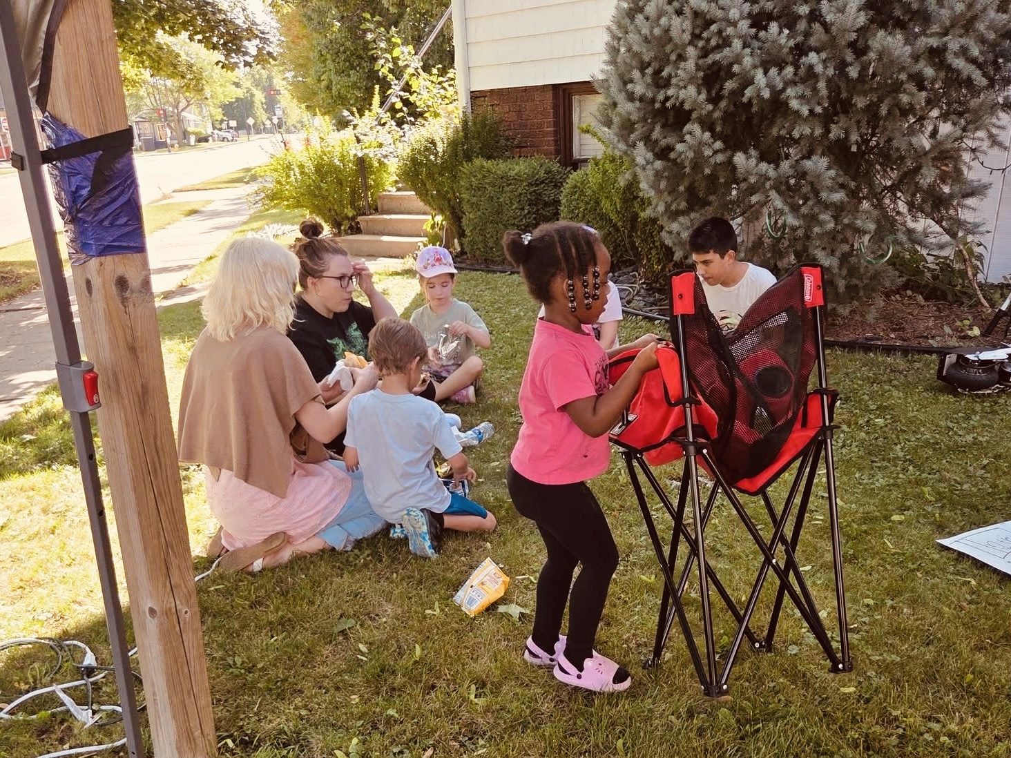 Children and families sitting together on the lawn